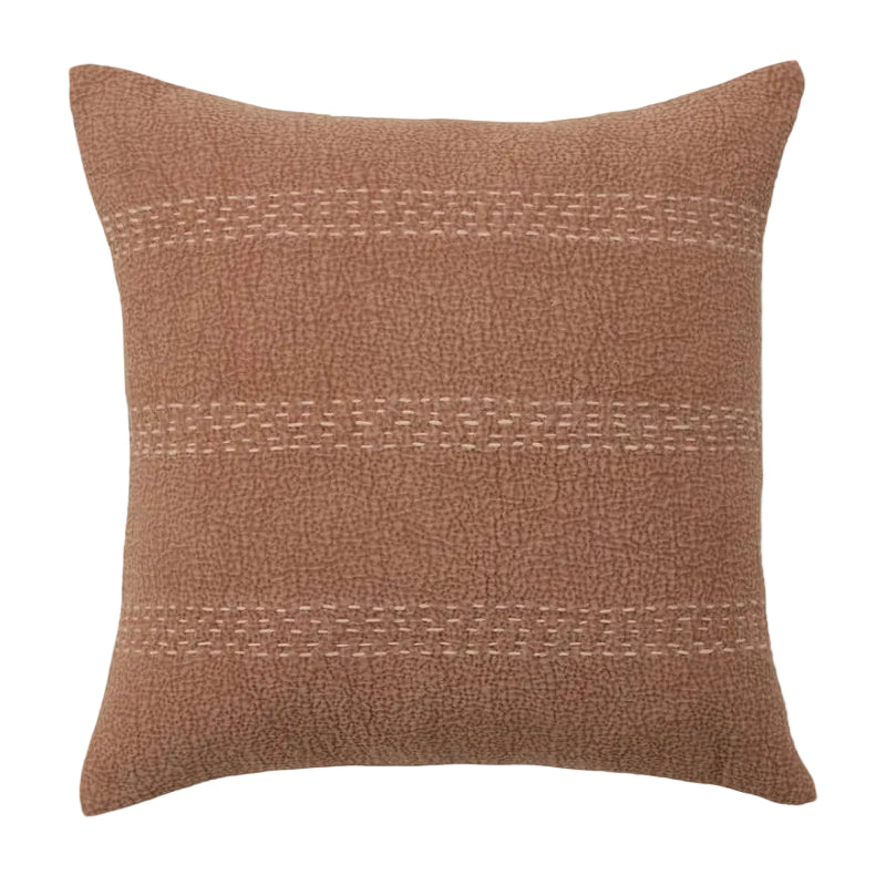 Brown textured pillow with decorative stitching on a white background