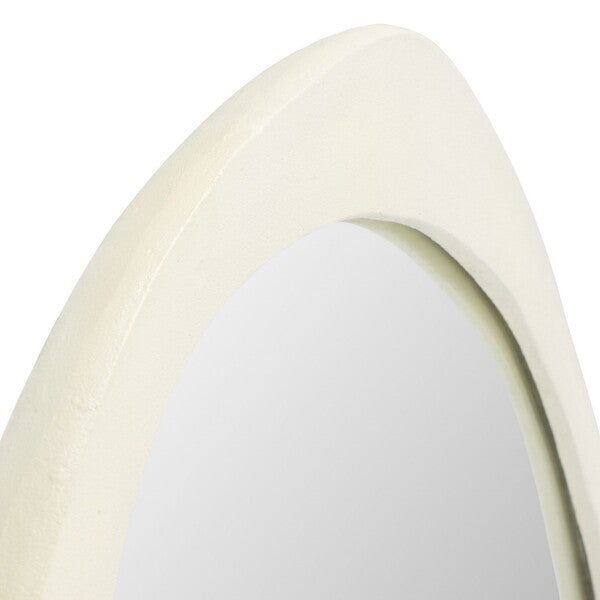 Close-up of a curved, beige-colored wall mirror on a white background