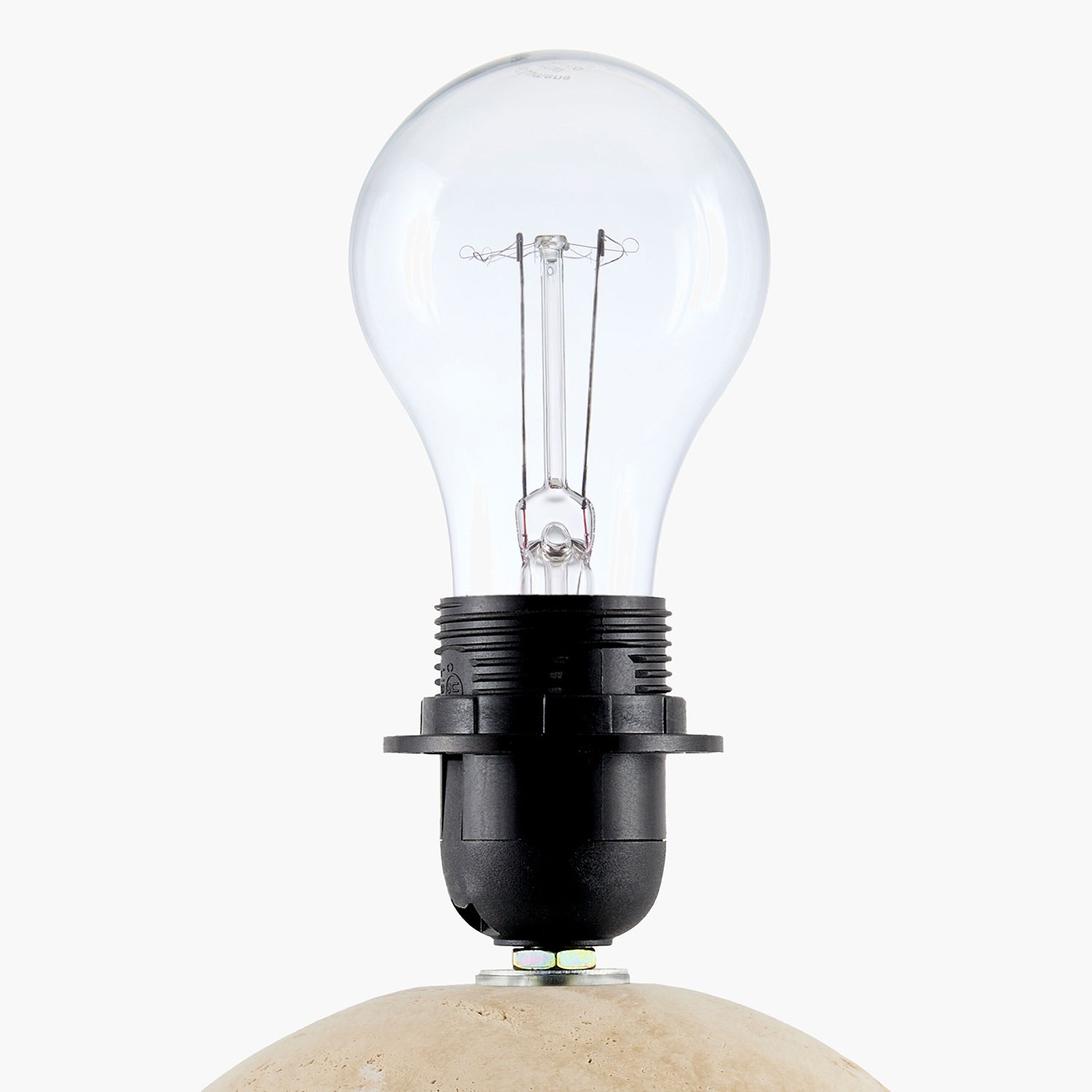 Clear light bulb on a stone base with a white background