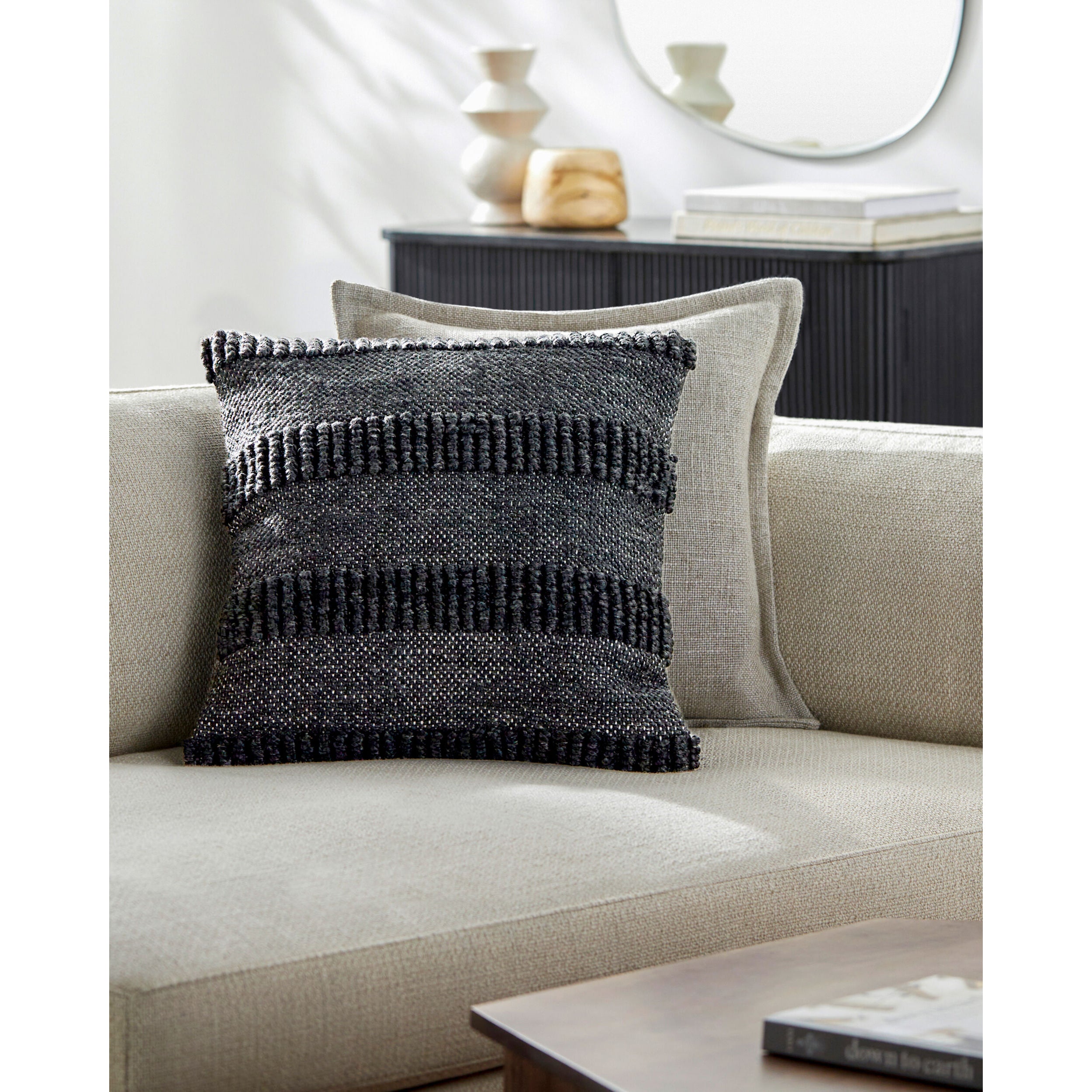 Gray striped woven throw pillow on beige couch