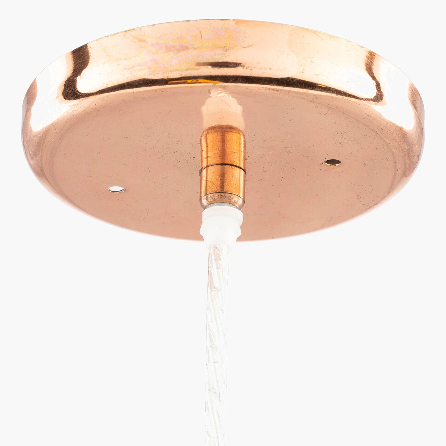 Close-up of a ceiling light fixture with a copper finish on a white background