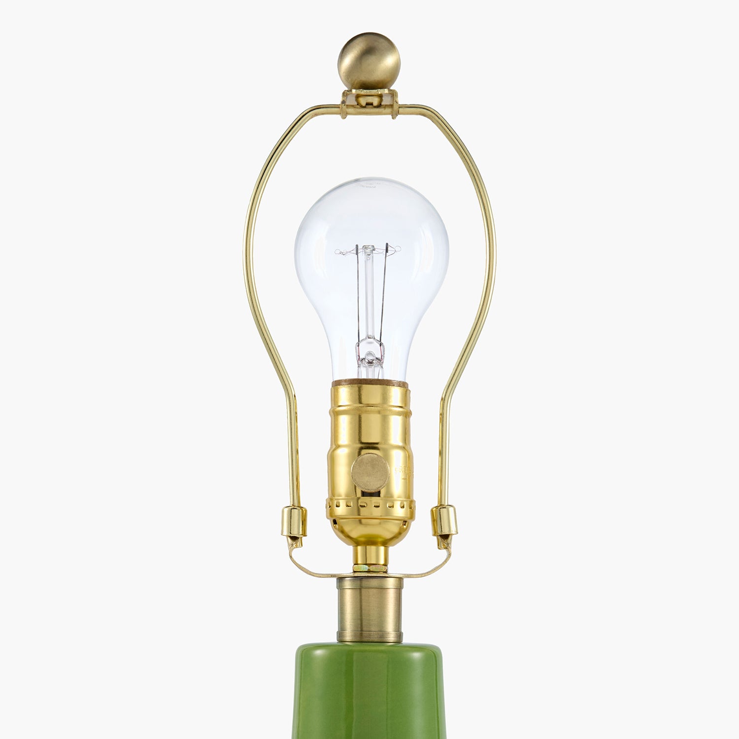 Decorative lamp with gold fixture and green base on a white background