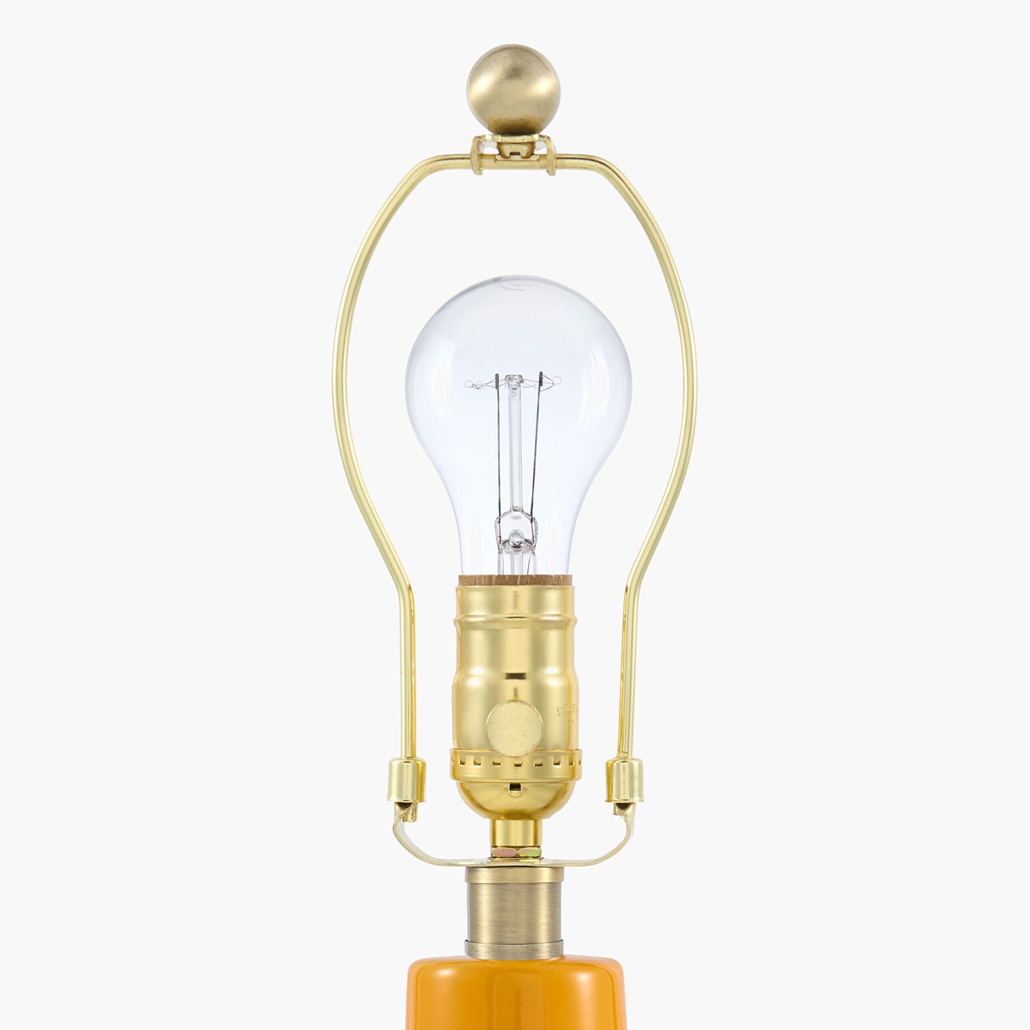 Vintage-style light bulb with gold fixture on a white background