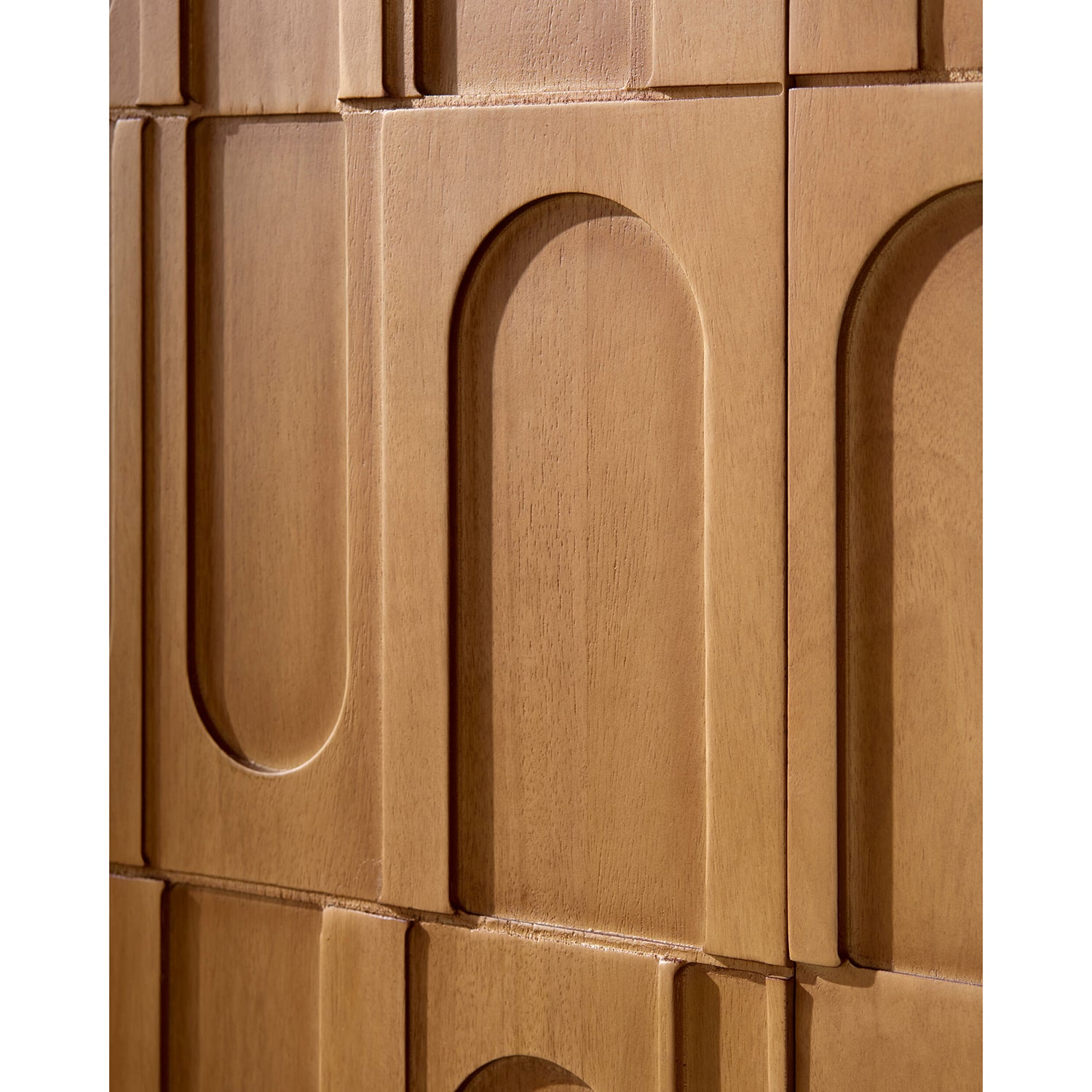 Close-up of wooden cabinet with arched cutouts on a white background