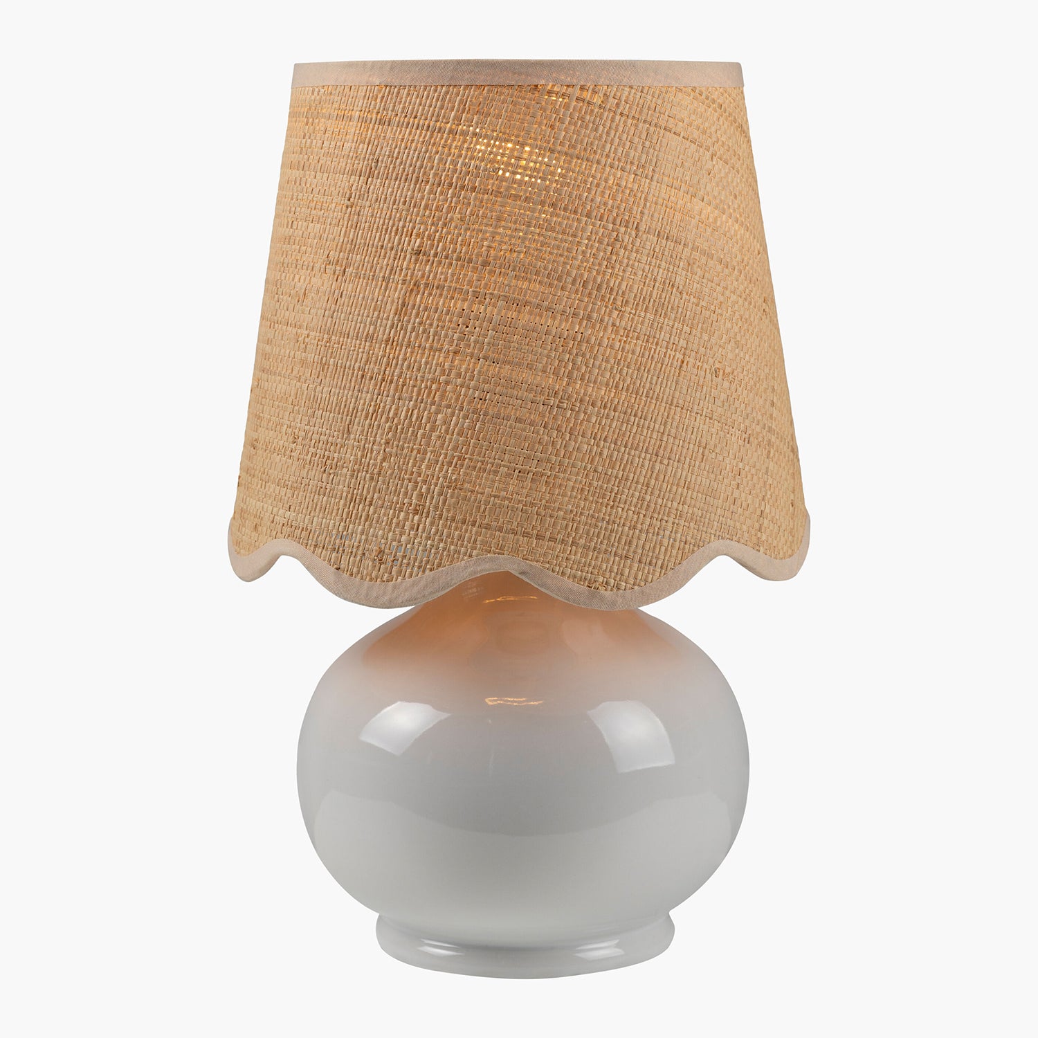 Table lamp with a beige textured shade and white base on a white background