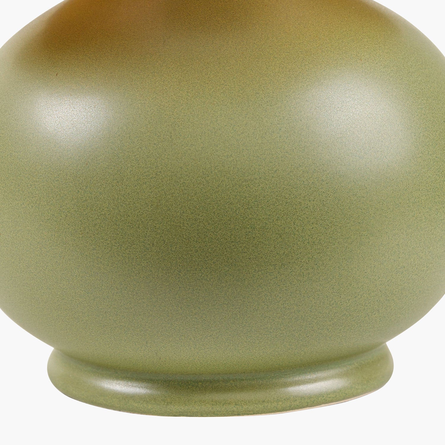 Green ceramic lamp base on a white background