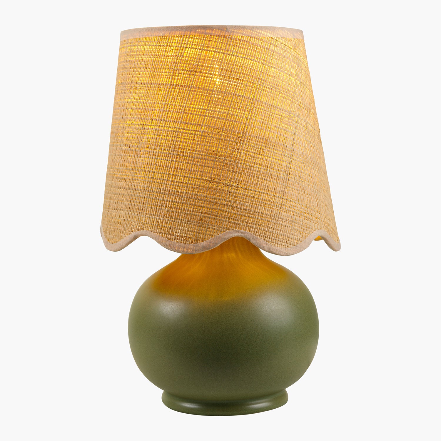 Table lamp with a textured beige shade and green base on a white background