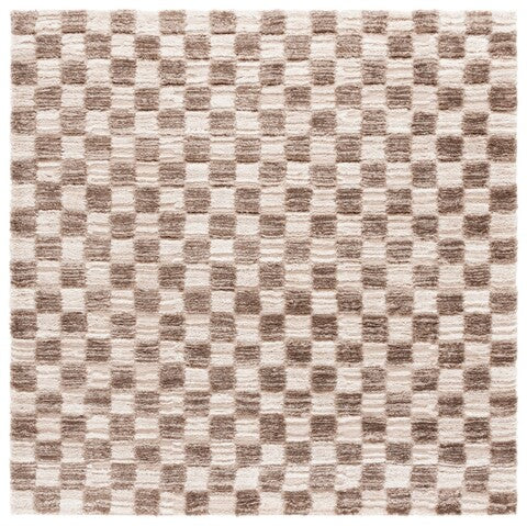 A shaggy area rug with a geometric pattern in ivory and brown tones.