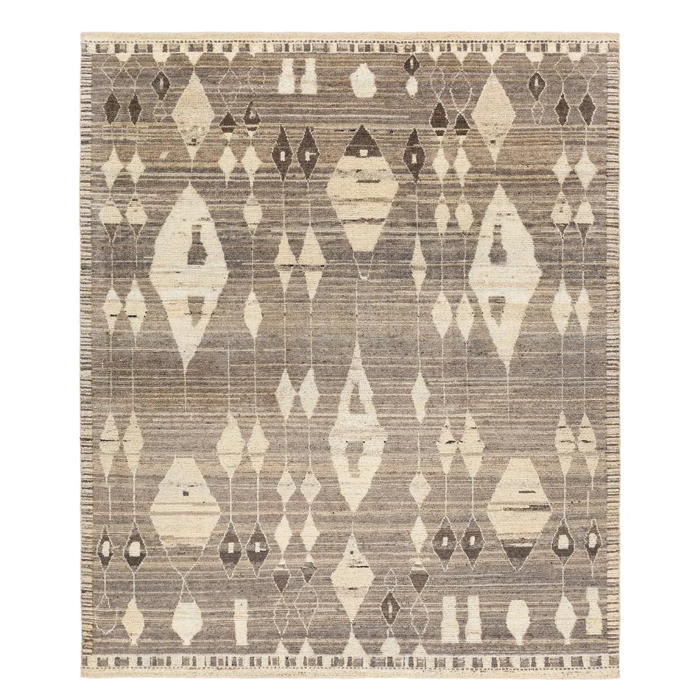 A modern Moroccan design area rug featuring a diamond pattern in shades of gray, cream, taupe, and tan.