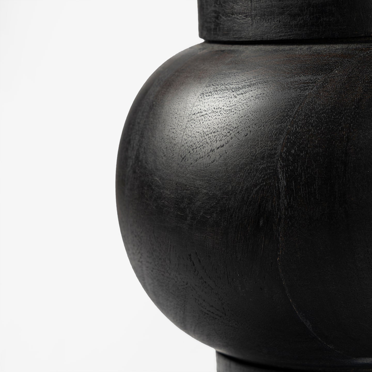 Close-up of a dark wooden table base on a white background