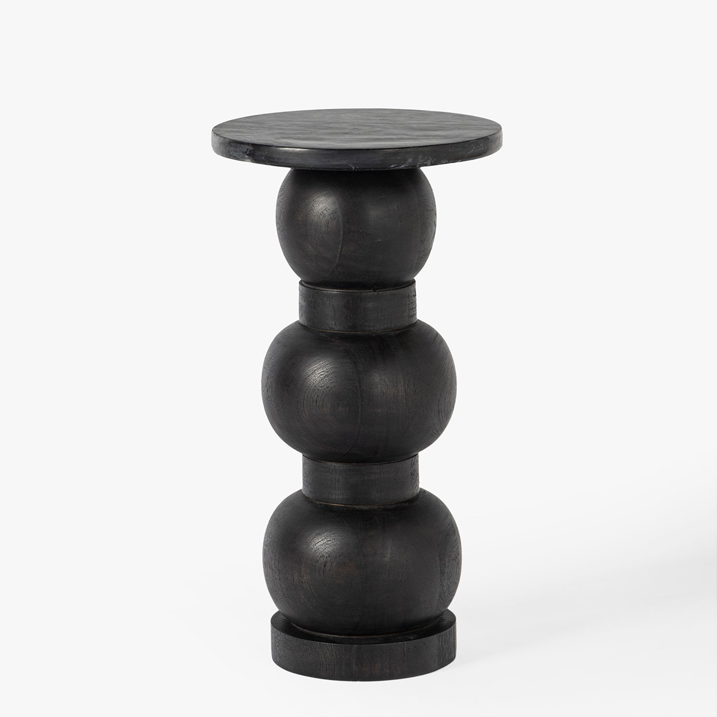 Black side table with spherical design on a white background