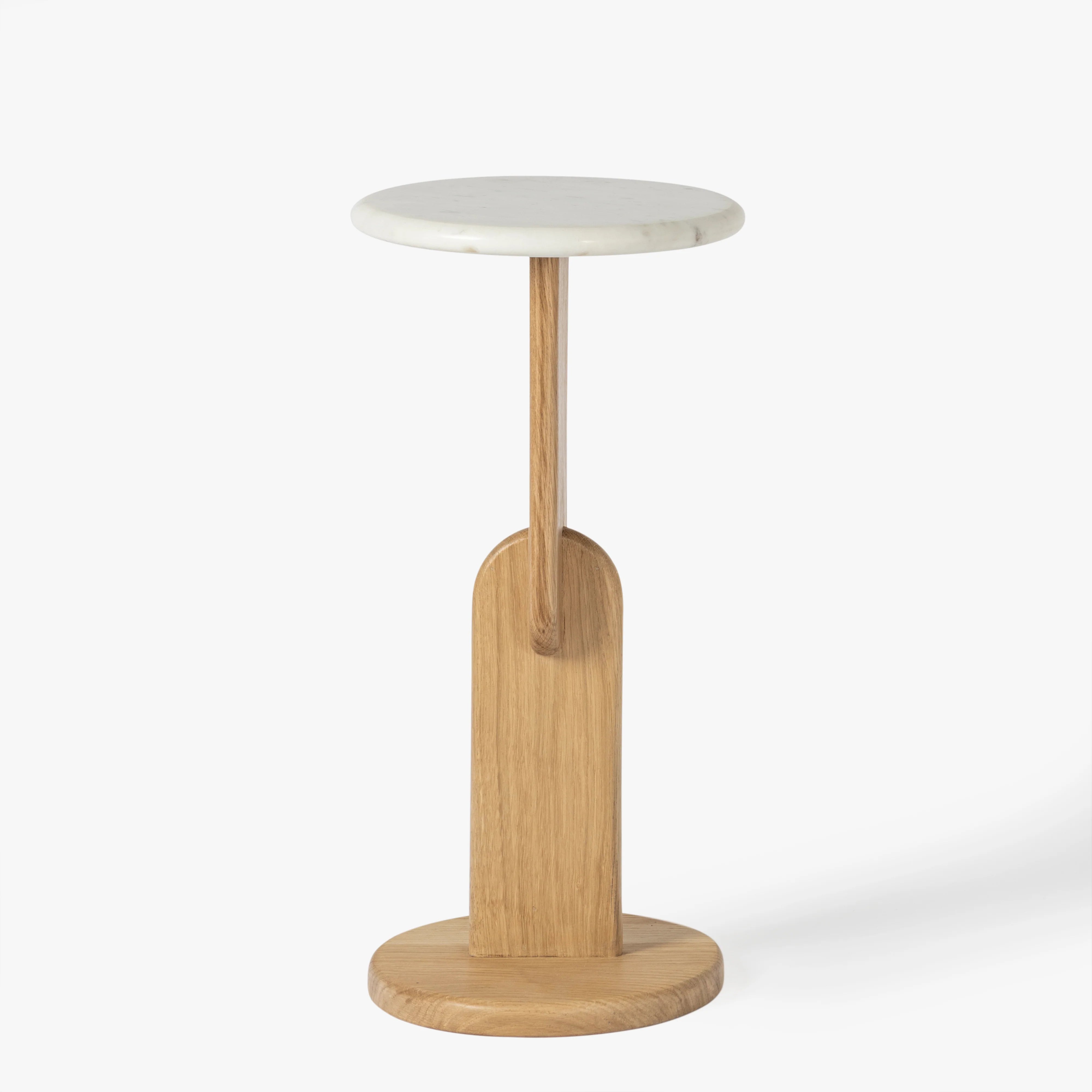 Small round table with a white top and wooden base on a white background