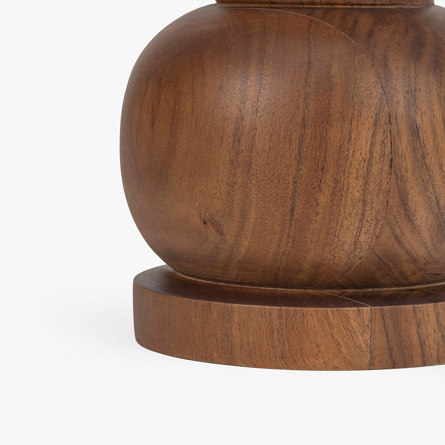 Close-up of a wooden side table base on a white background