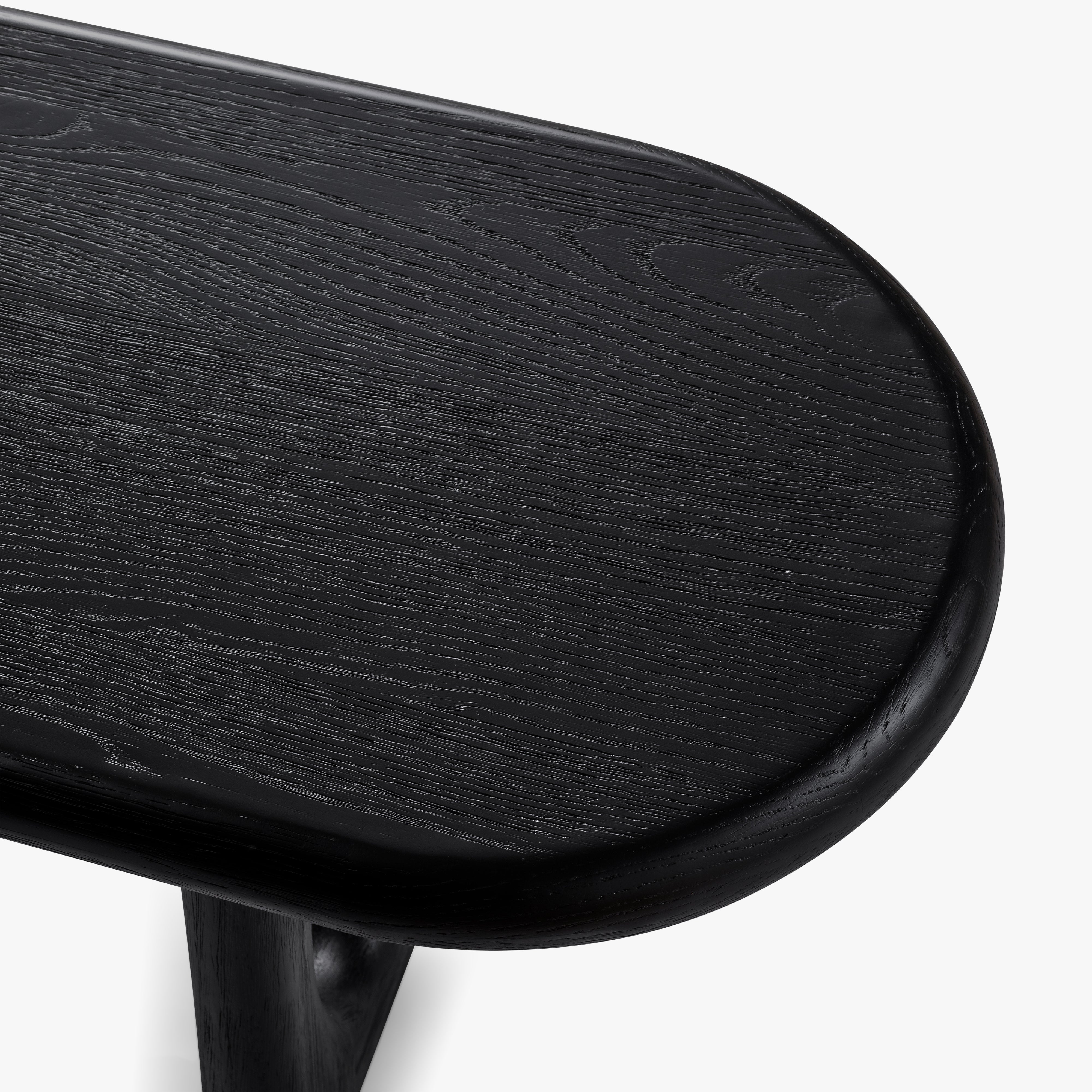 Close-up of a black wooden bench on a white background