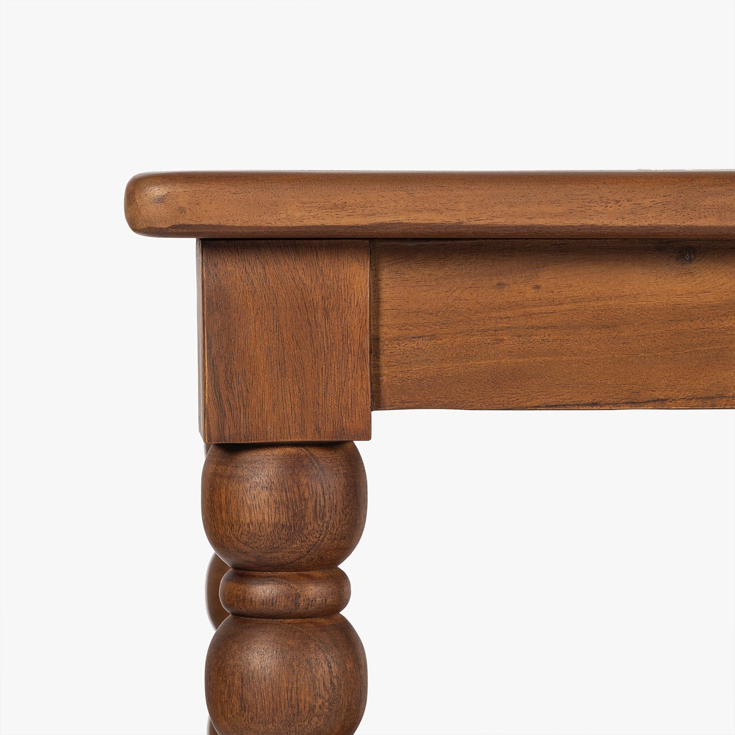 Close-up of a wooden table leg with a white background