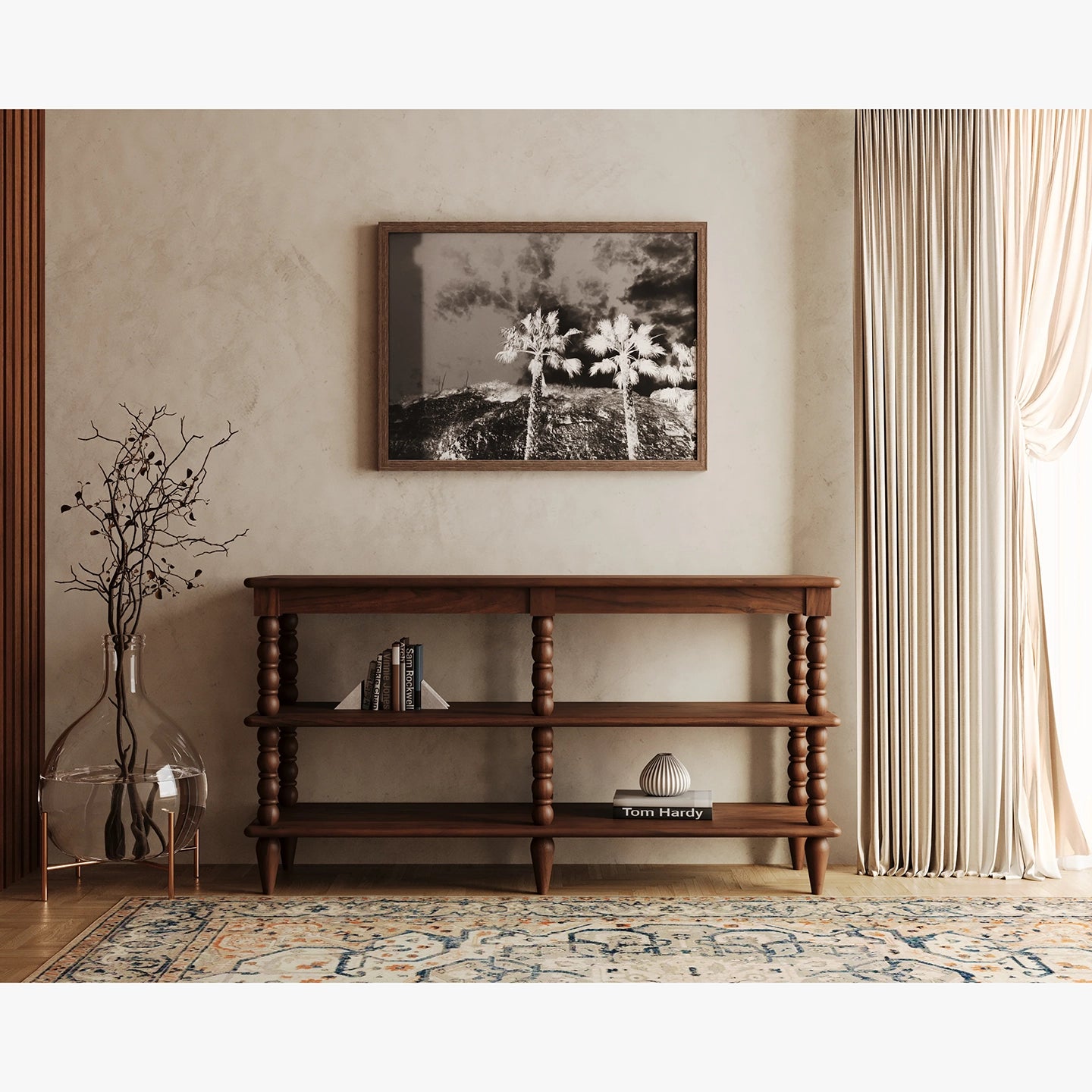 Wooden console table in a living room with a framed picture on the wall.
