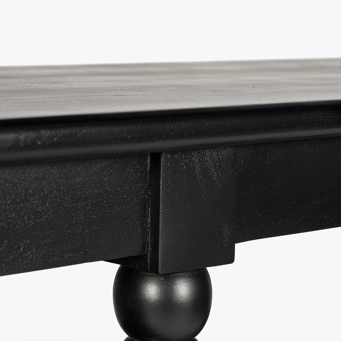 Close-up of a black wooden bookcase shelf