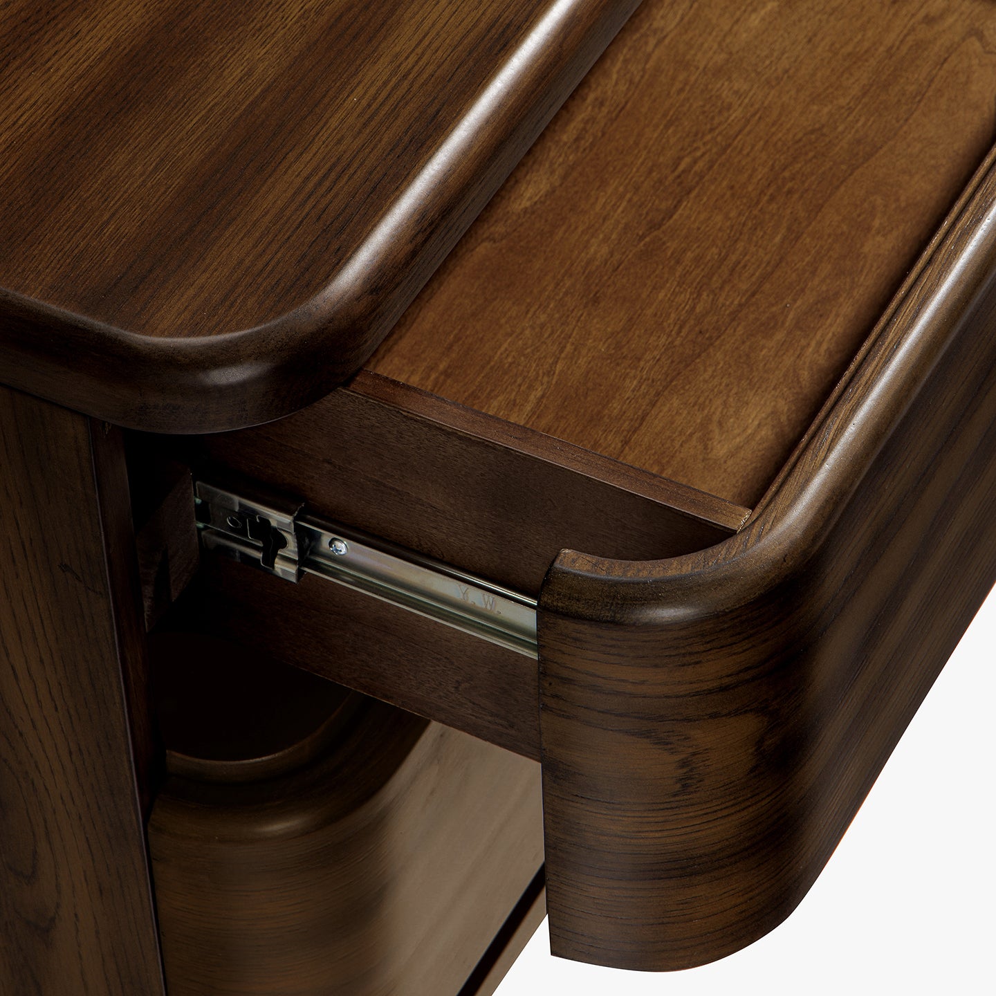 Close-up of a wooden nightstand with a drawer being pulled out