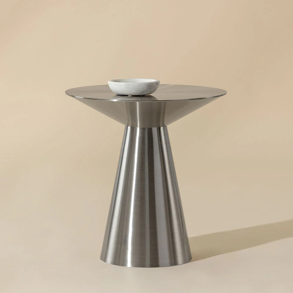 Stainless steel side table with a bowl on a beige background
