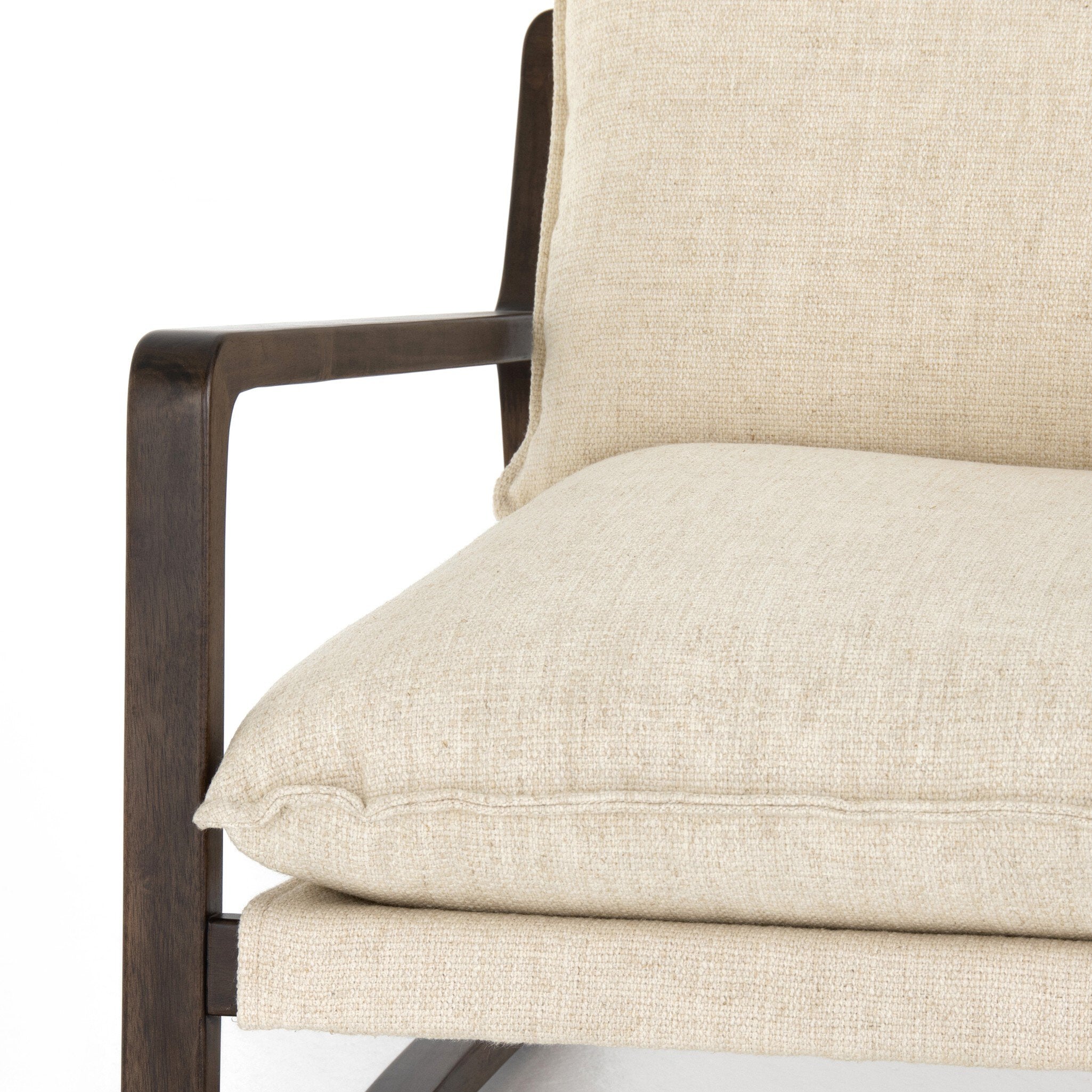 Close-up of a beige upholstered chair with a dark wooden frame on a white background