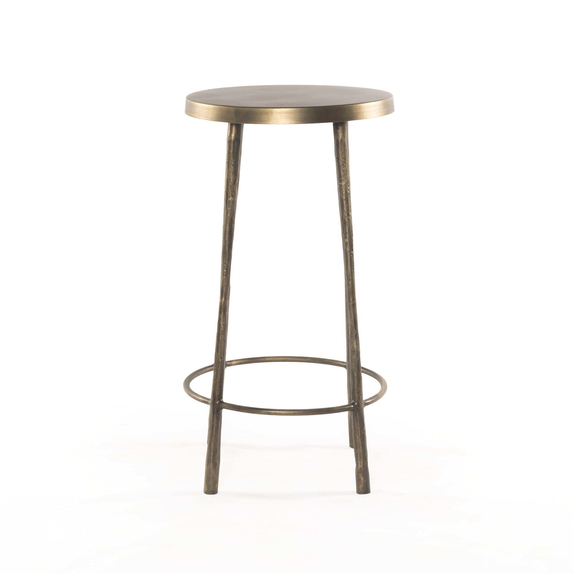 Brass bar stool with round seat on a white background