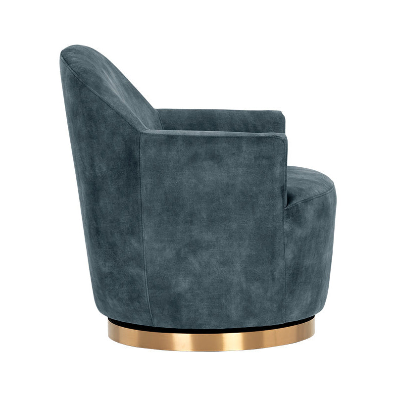 A modern barrel-style accent chair upholstered in textured slate blue velvet, featuring a round metallic gold base, shown from a three-quarters angle on a white background.