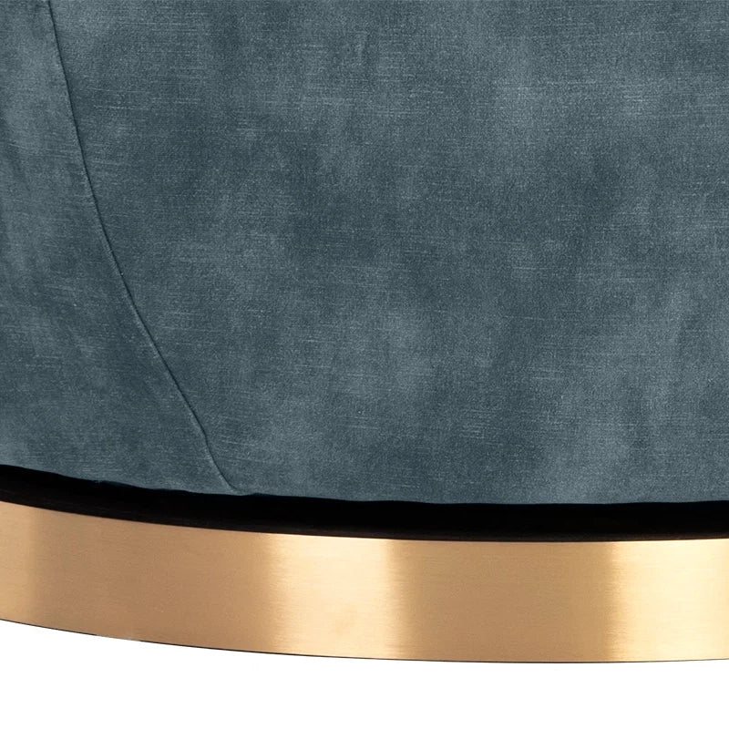Close-up of a textured slate blue upholstered surface with a brushed gold metallic band along the bottom edge.