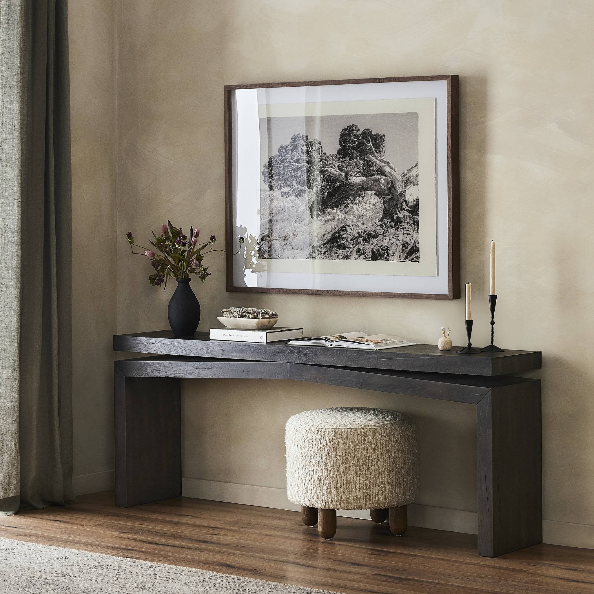 Corner desk with decorative items against a beige wall