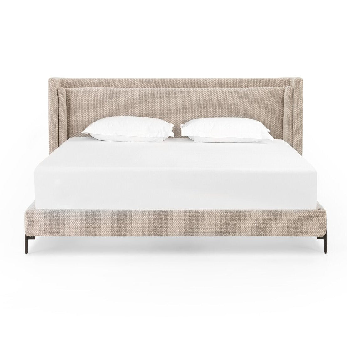 Beige upholstered bed with white bedding on a white background