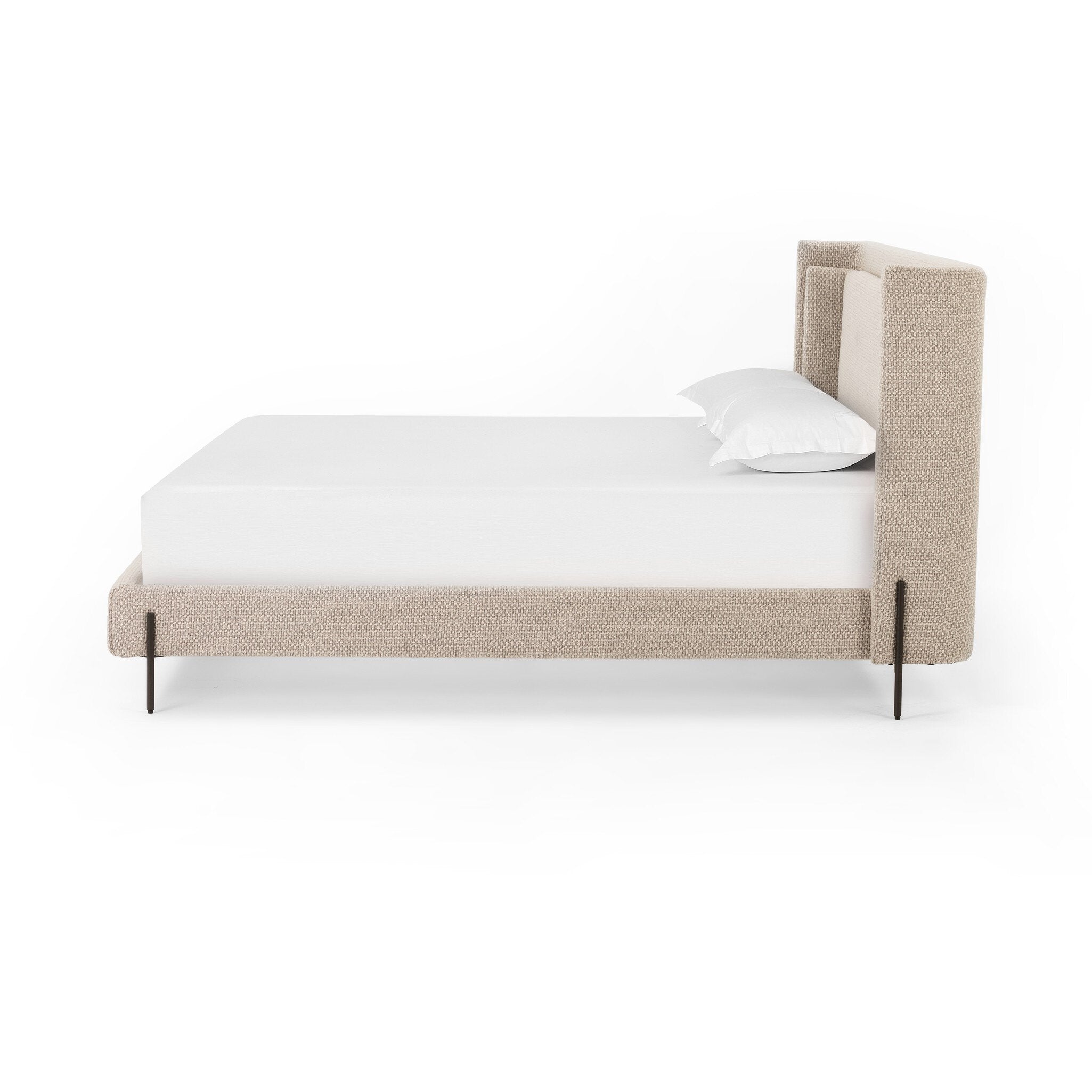 Beige upholstered bed with white mattress and pillow on a white background