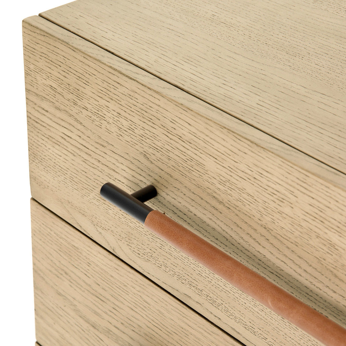 Close-up of a wooden drawer with a leather handle on a white background