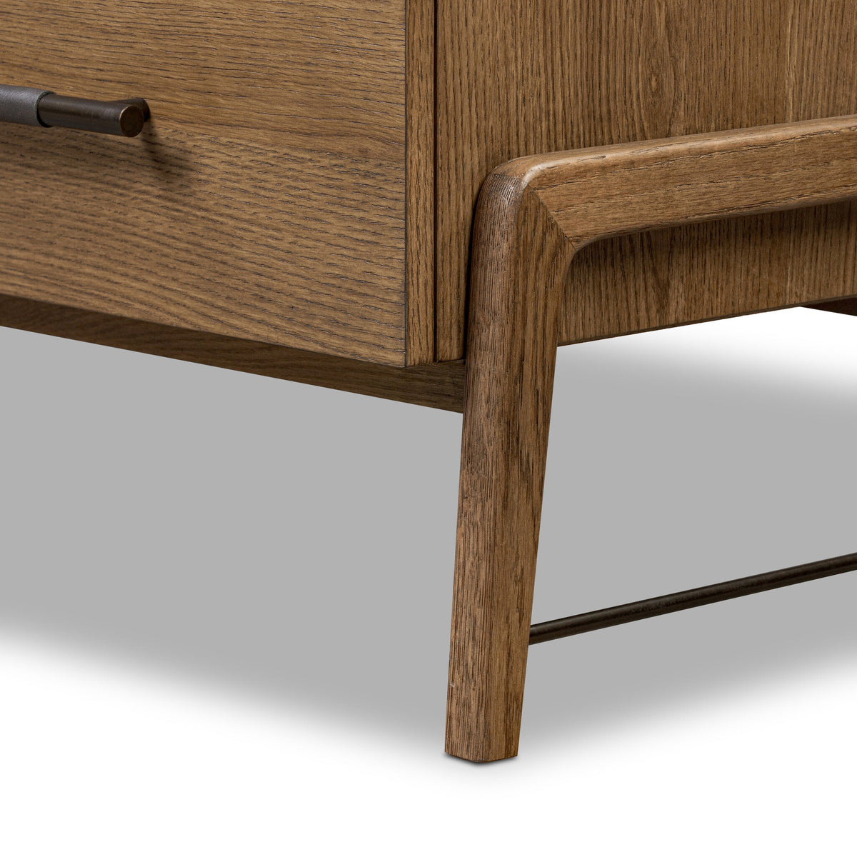 Close-up of a wooden drawer with a smooth finish on a light gray background