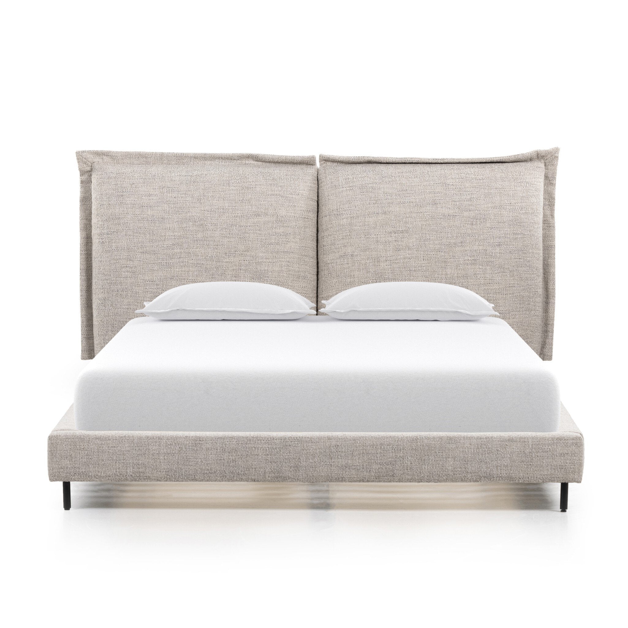 Bed with beige upholstered headboard and white bedding on a white background