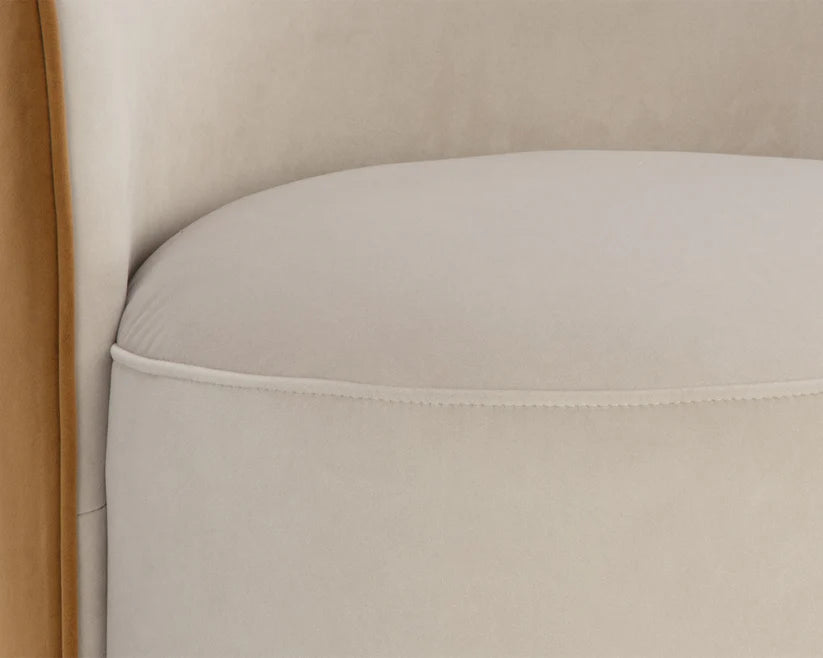 Close-up of a beige upholstered chair with a wooden armrest.