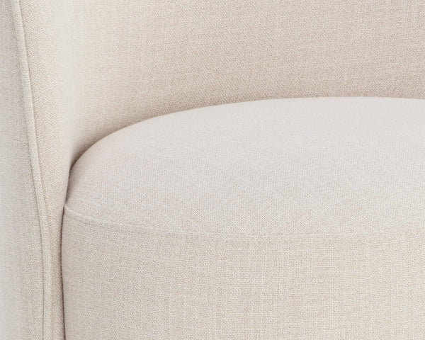 Close-up of a beige upholstered chair with a focus on the fabric texture.