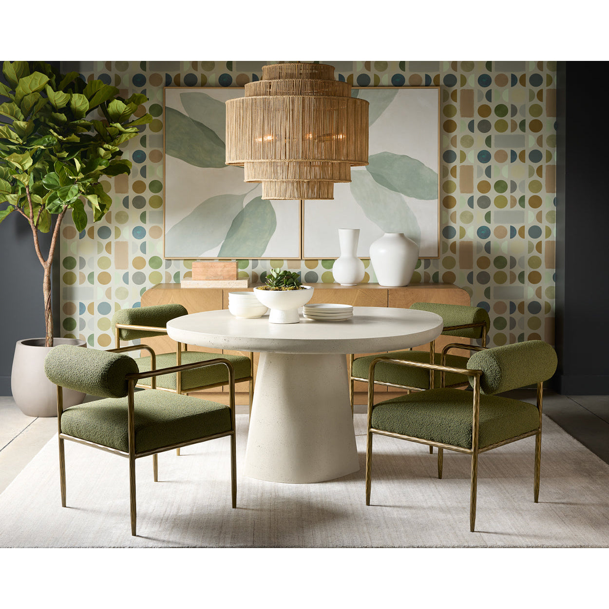 Modern dining room with a round table and green chairs against a patterned wall.