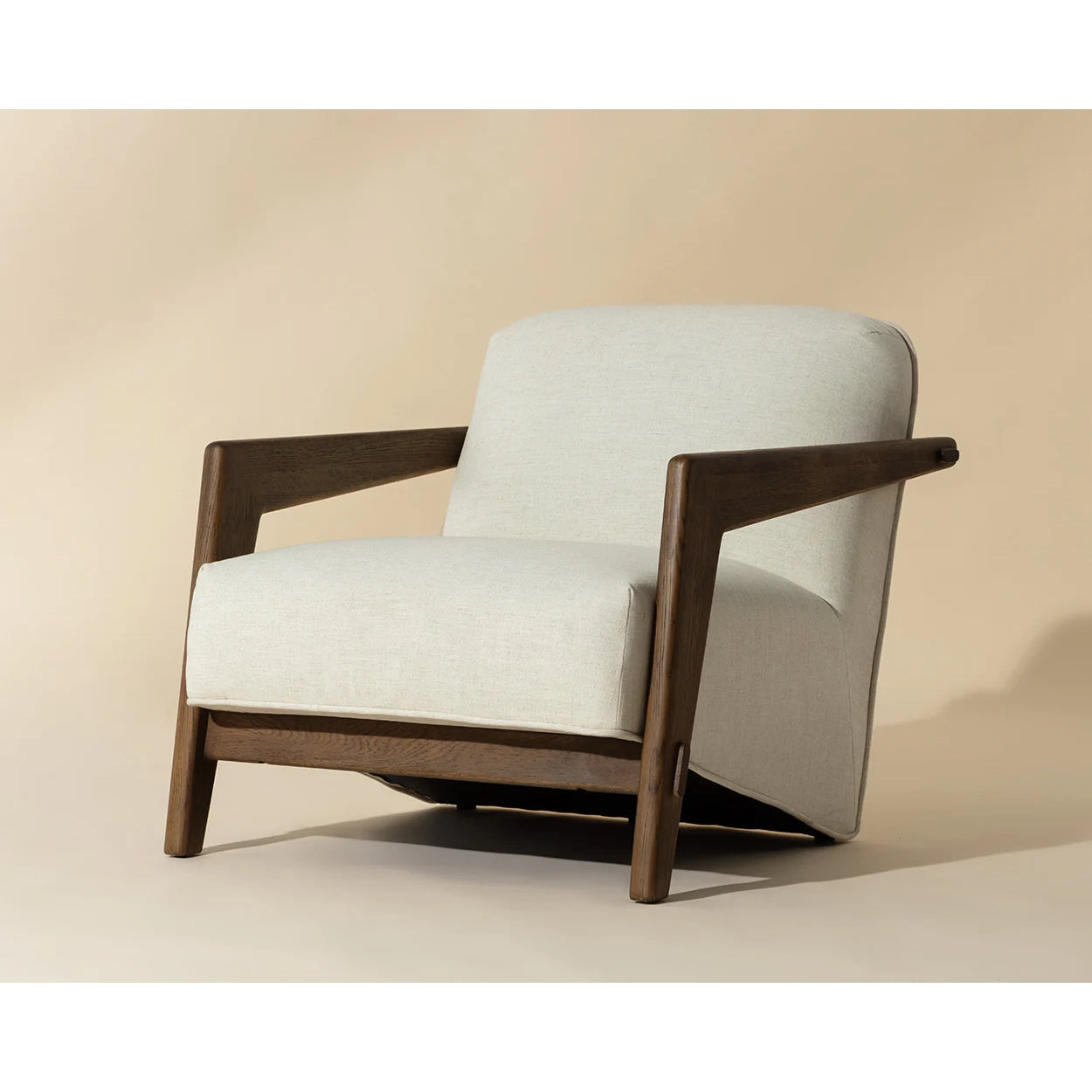 A modern accent chair with a light beige textured fabric seat and back cushion, supported by a dark brown wooden frame, shown against a solid beige background.