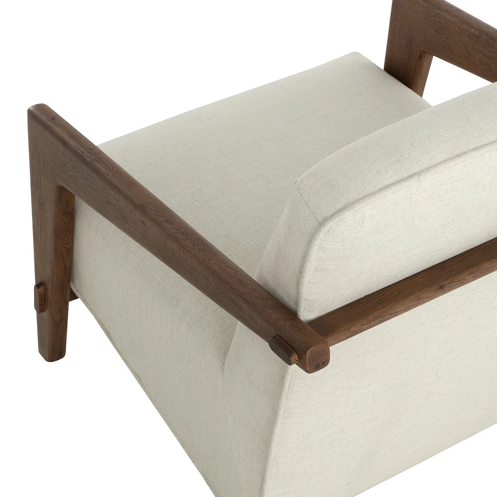 Close-up of a modern armchair with cream-colored textured fabric upholstery and a dark brown wooden frame, showing the backrest, seat cushion, and armrests against a white background.