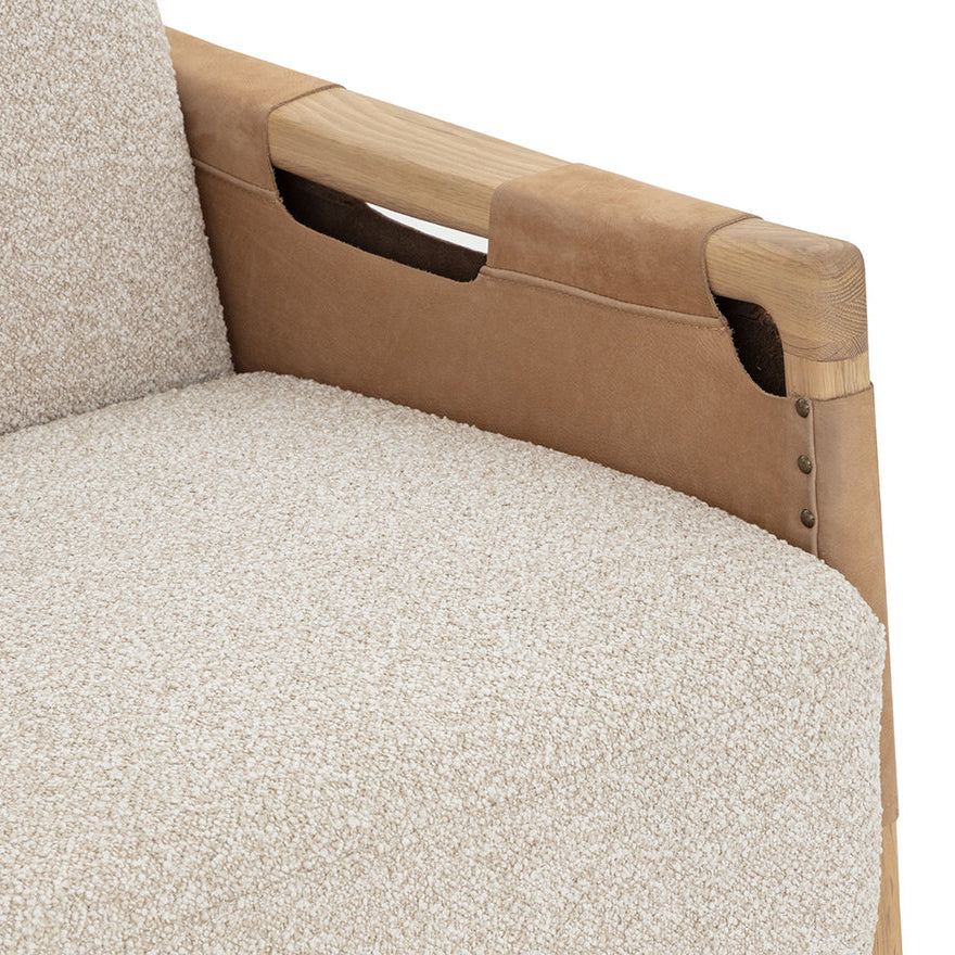 Close-up of a beige upholstered chair with wooden armrests on a white background
