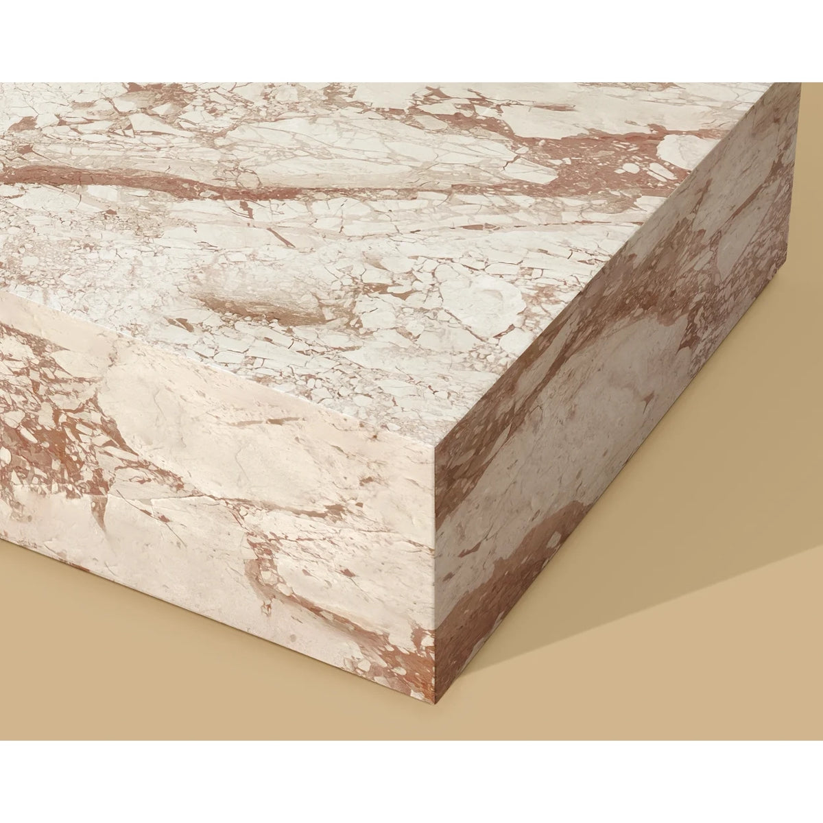 A rectangular marble slab or block with a warm off-white to beige base and prominent coppery brown veining, shown at an angle against a solid beige background.