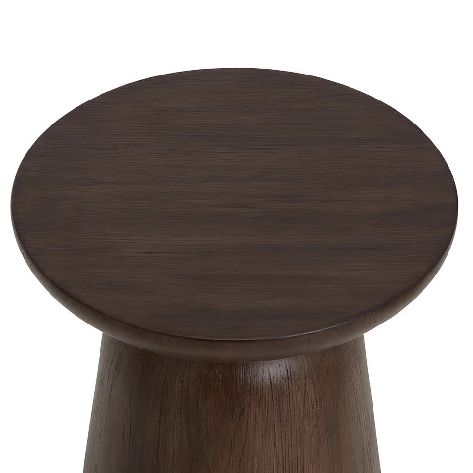 A close-up top-down view of a dark brown wooden look stool or side table with a round seat and tapered base, shown on a plain white background.