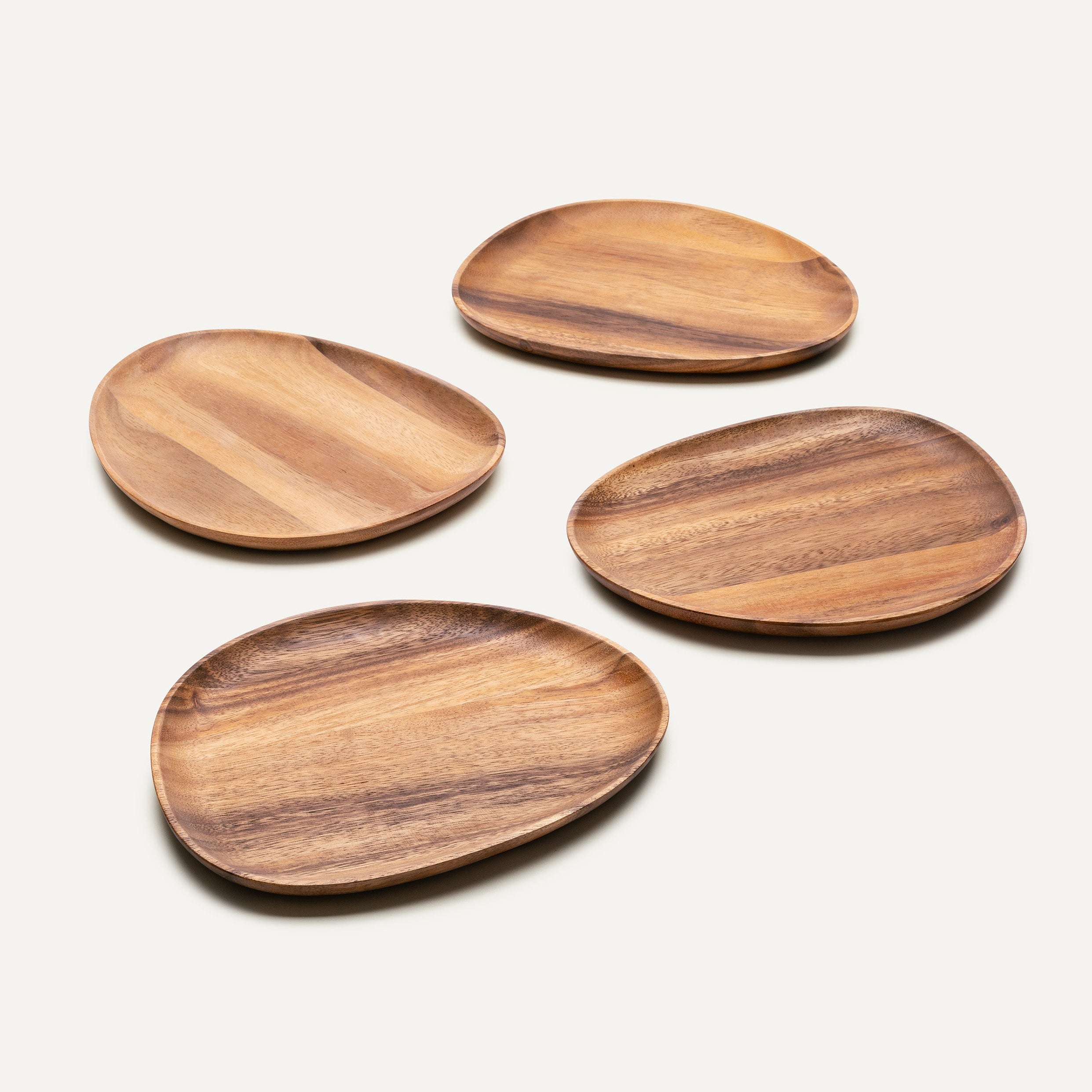 Four wooden plates on a light background