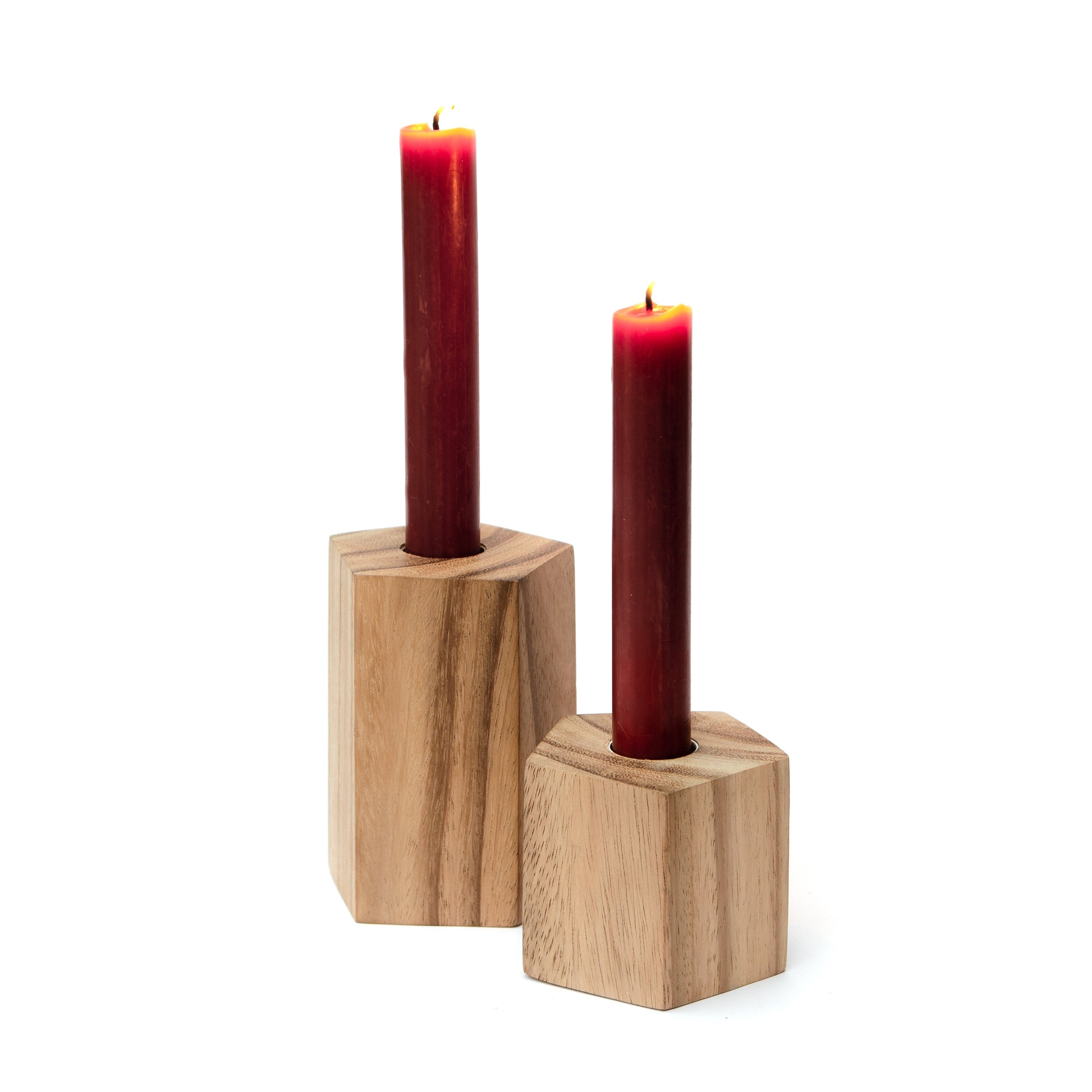 Two wooden candle holders with red candles on a white background