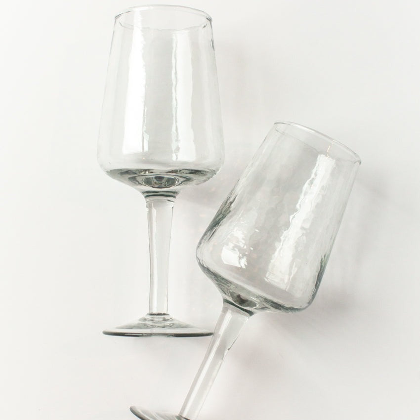 Two clear wine glasses on a white background