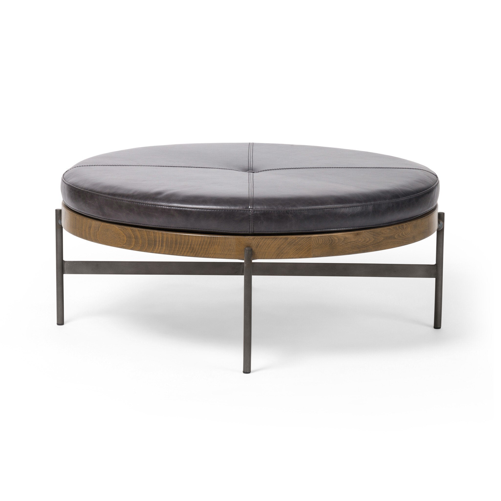 Round leather ottoman with wooden base and metal legs on a white background