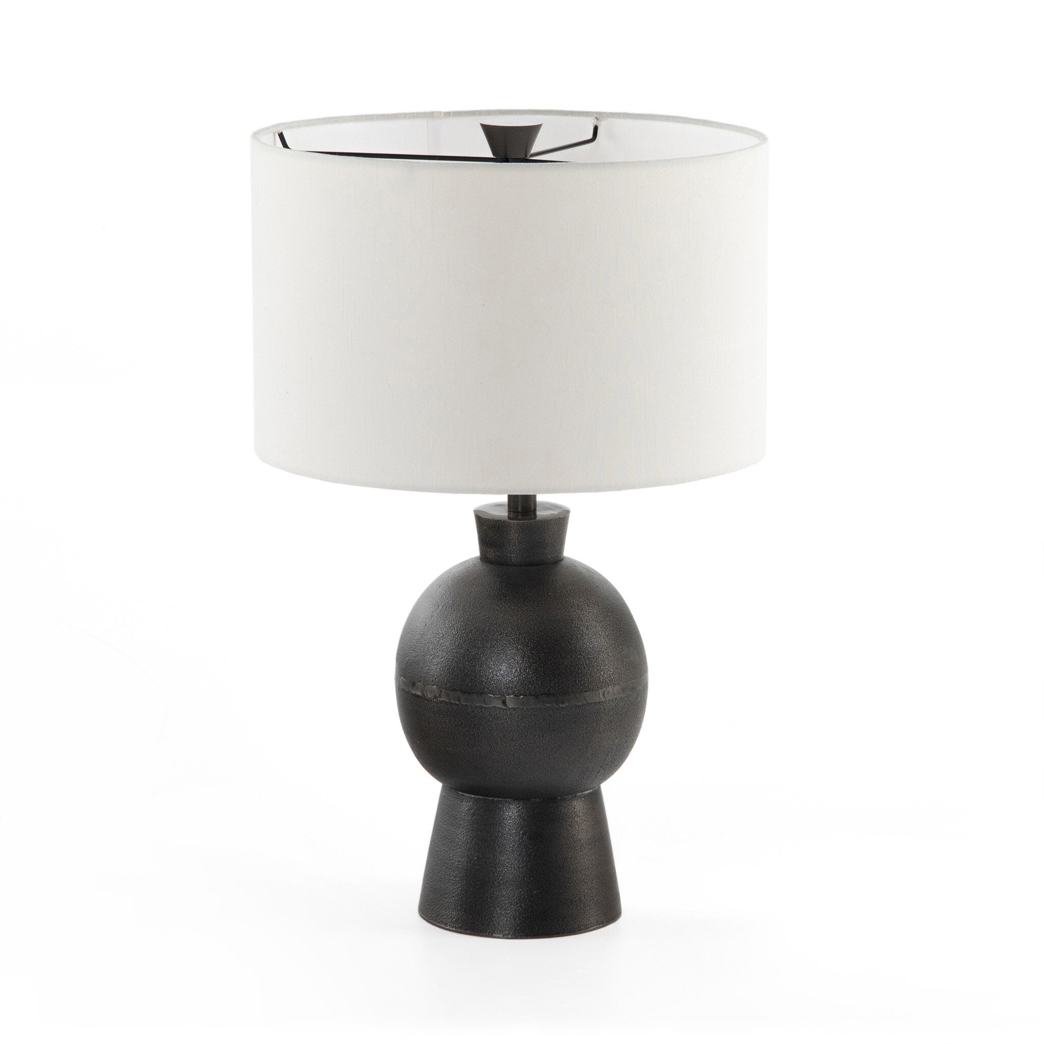 Table lamp with black base and white shade on a white background