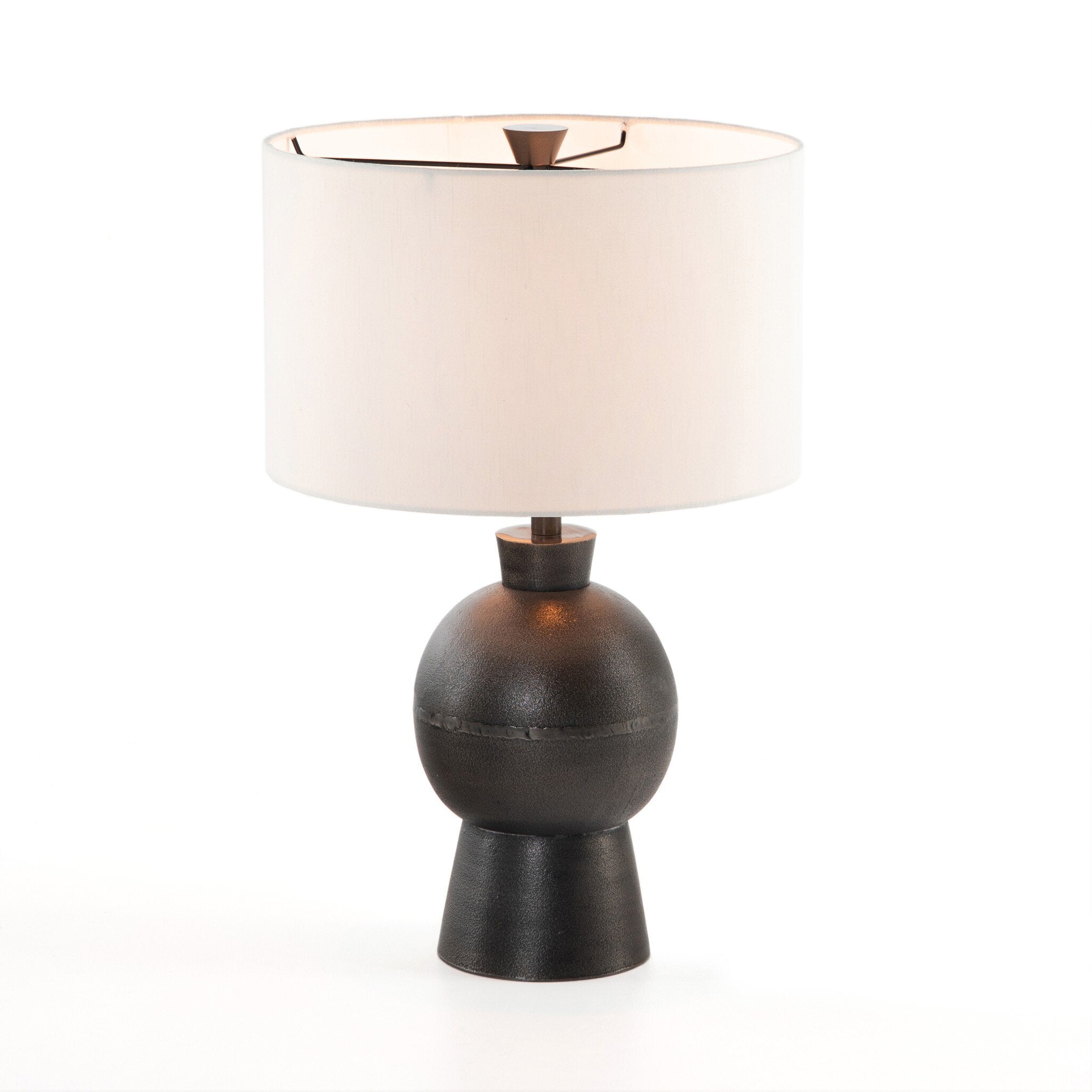 Table lamp with a dark brown base and white shade on a white background