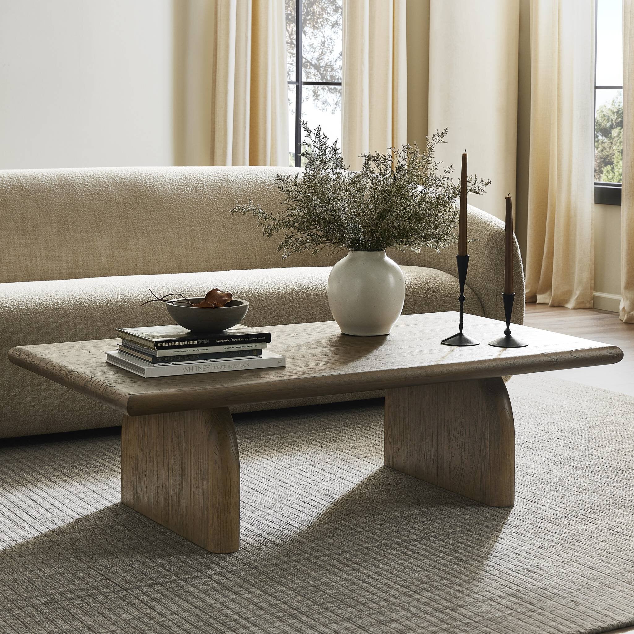 Wooden coffee table with decorative items in a living room setting