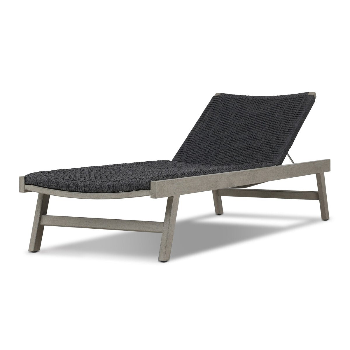 Modern lounge chair with dark woven backrest and light wooden frame on a white background
