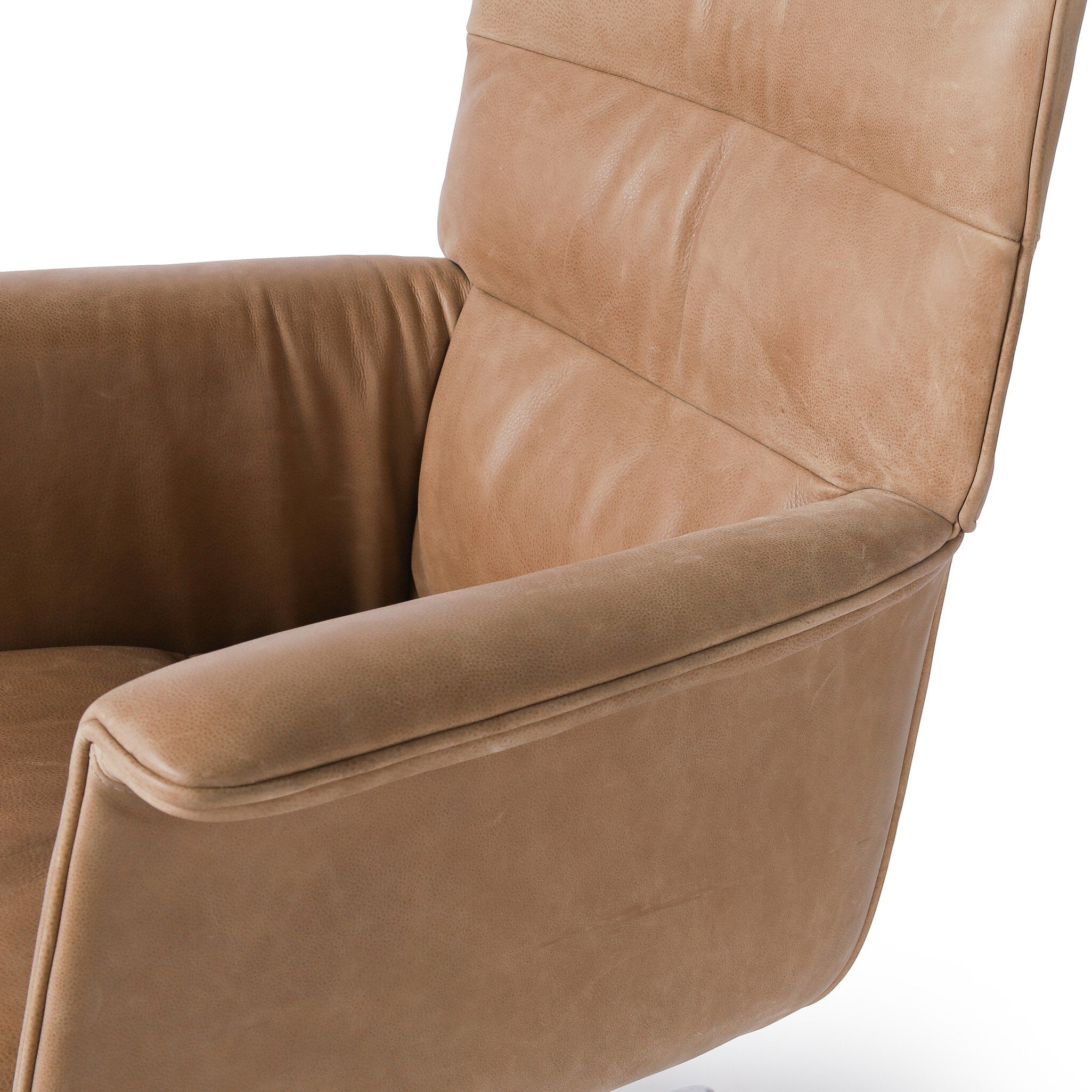 Close-up of a brown leather armchair on a white background